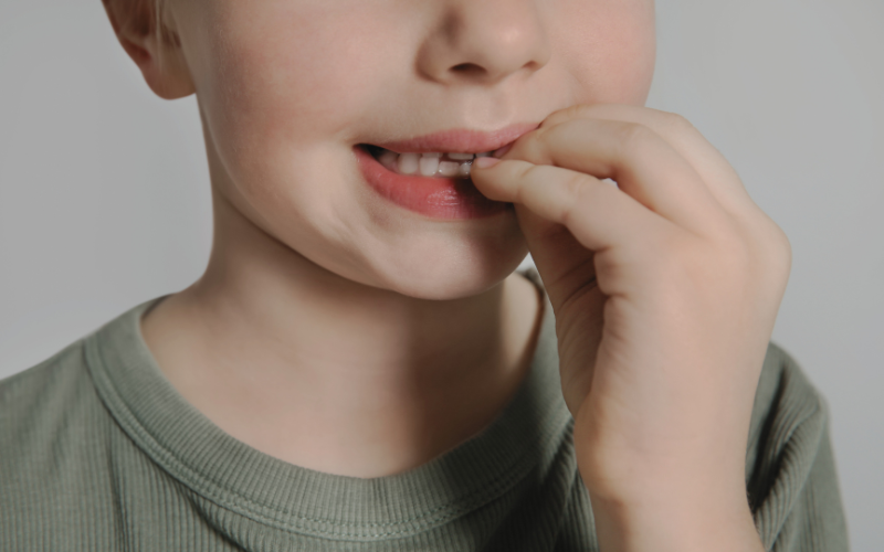 Child biting fingernails, a habit addressed by habit breaker appliances