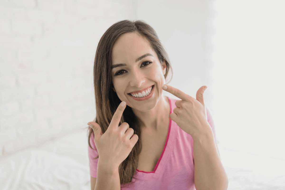 Woman smiling confidently, showcasing the impact of good oral health on mental well-being